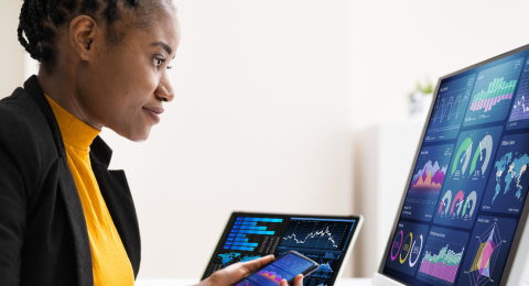 Woman working at computer with data overlay