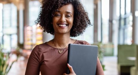 businesswoman holding digital tablet standing in a lobby