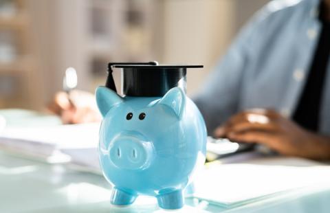 piggy bank on table with grad cap