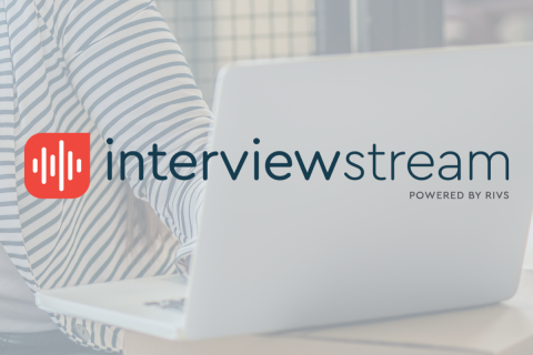 Interview Stream logo overlaid on a cropped image a person's striped shirt with an open laptop