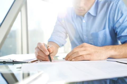 Man with pen and paperwork