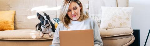 Woman on laptop with dog