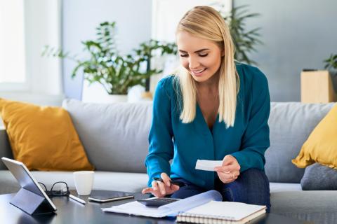 Woman with calculator and receipt