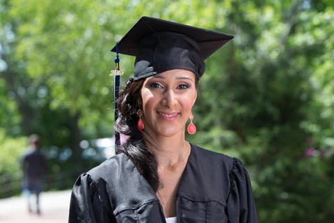 Smiling woman in graduation cap and gown