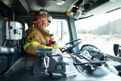 firefighter sitting inside a fire truck