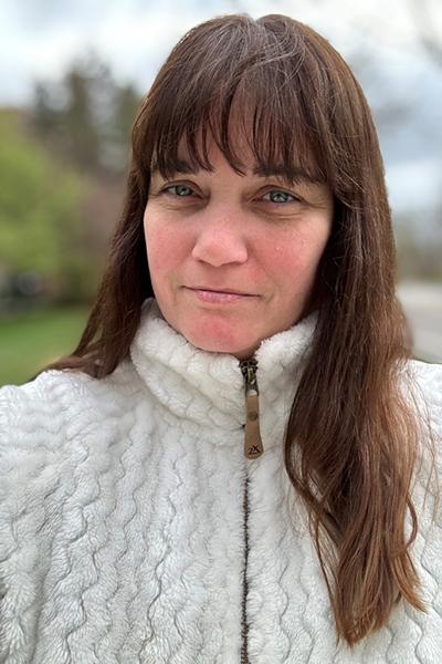 close up of a woman with brown hair outside