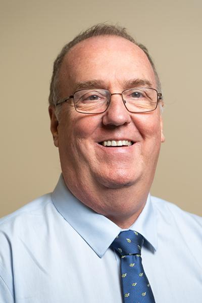 Headshot of a middle aged man with glasses