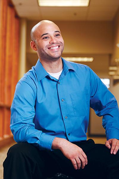 headshot of a man wearing a blue shirt