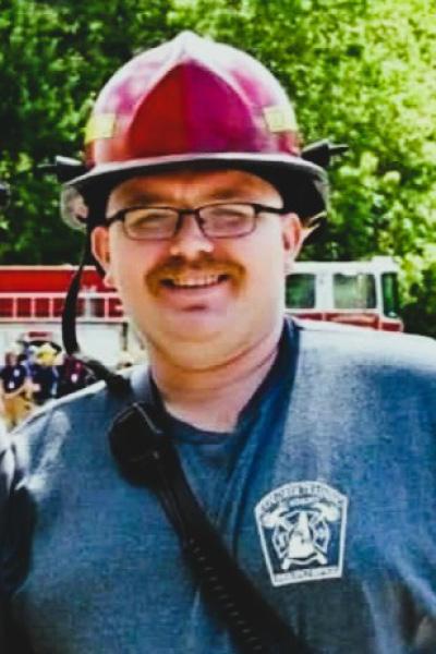 photo of a male firefighter with a safety helmet on
